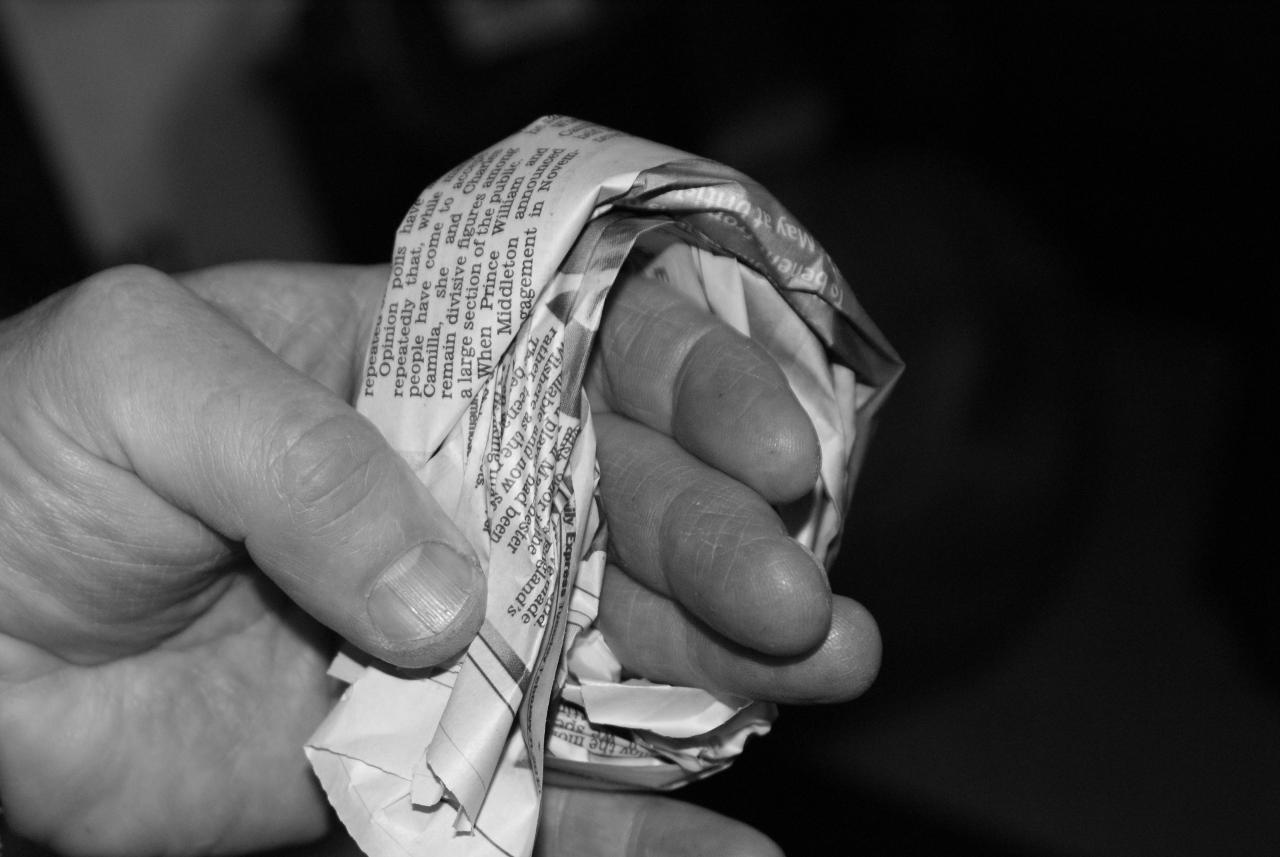 Sheet of newspaper folded around finger