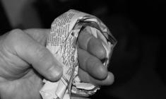 Sheet of newspaper folded around finger